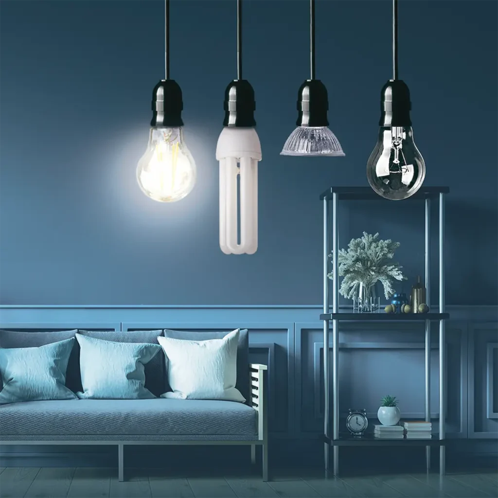 Olika typer av ledlampor och en glödlampa hänger framför en soffa och en hylla.